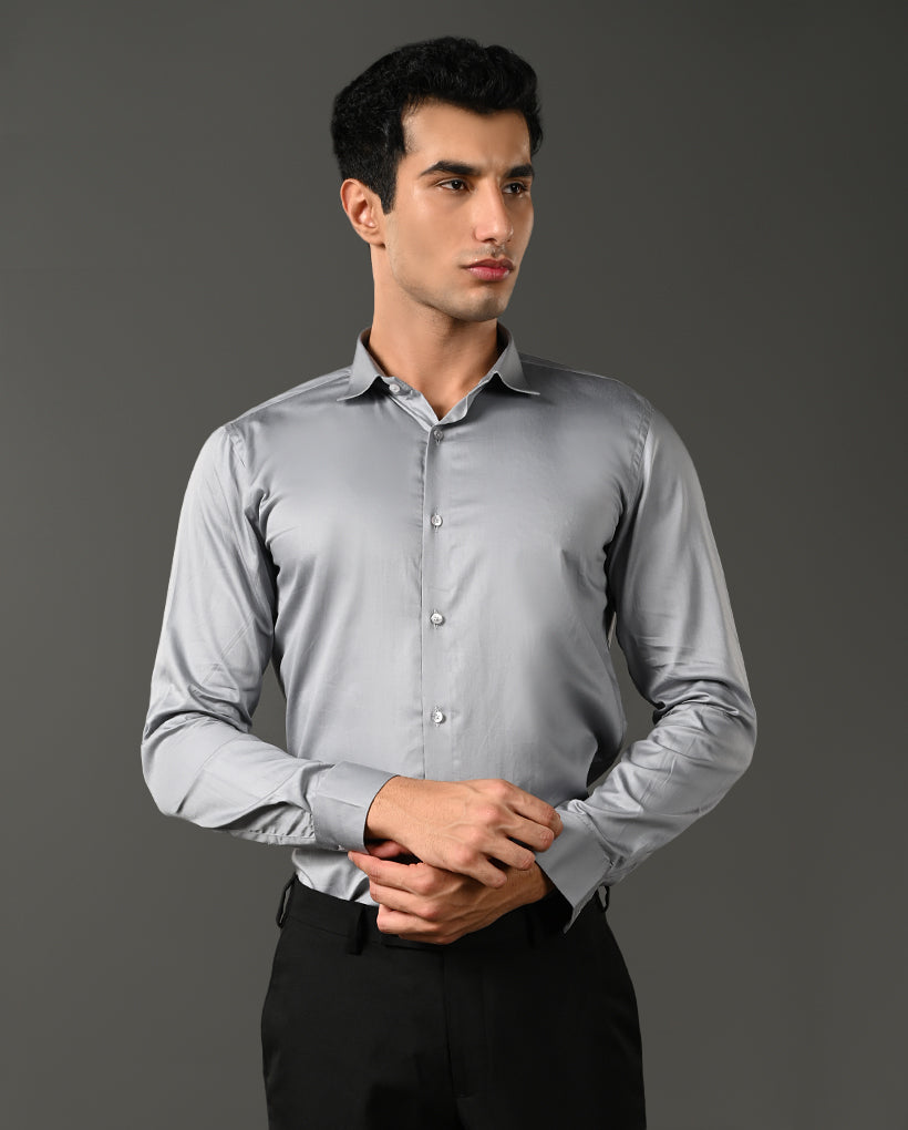 Man wearing a light gray dress shirt against a dark background- formal shirt for men