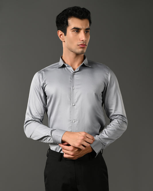 Man wearing a light gray dress shirt against a dark background- formal shirt for men