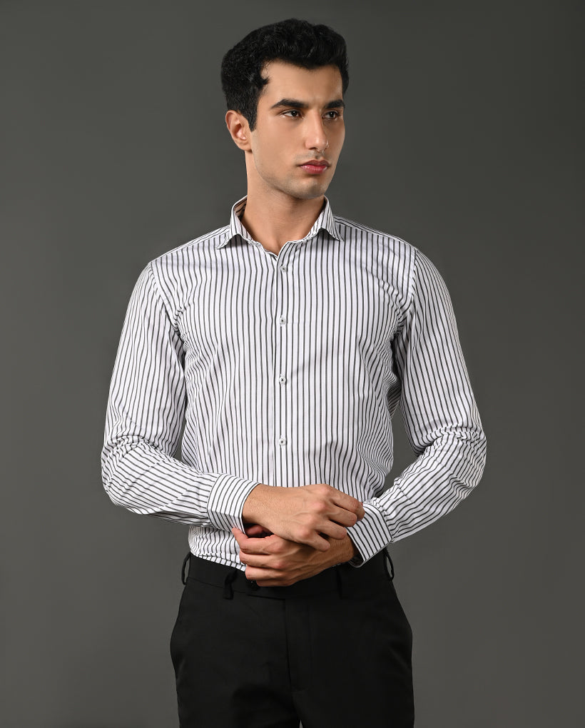Man wearing a striped shirt against a gray background