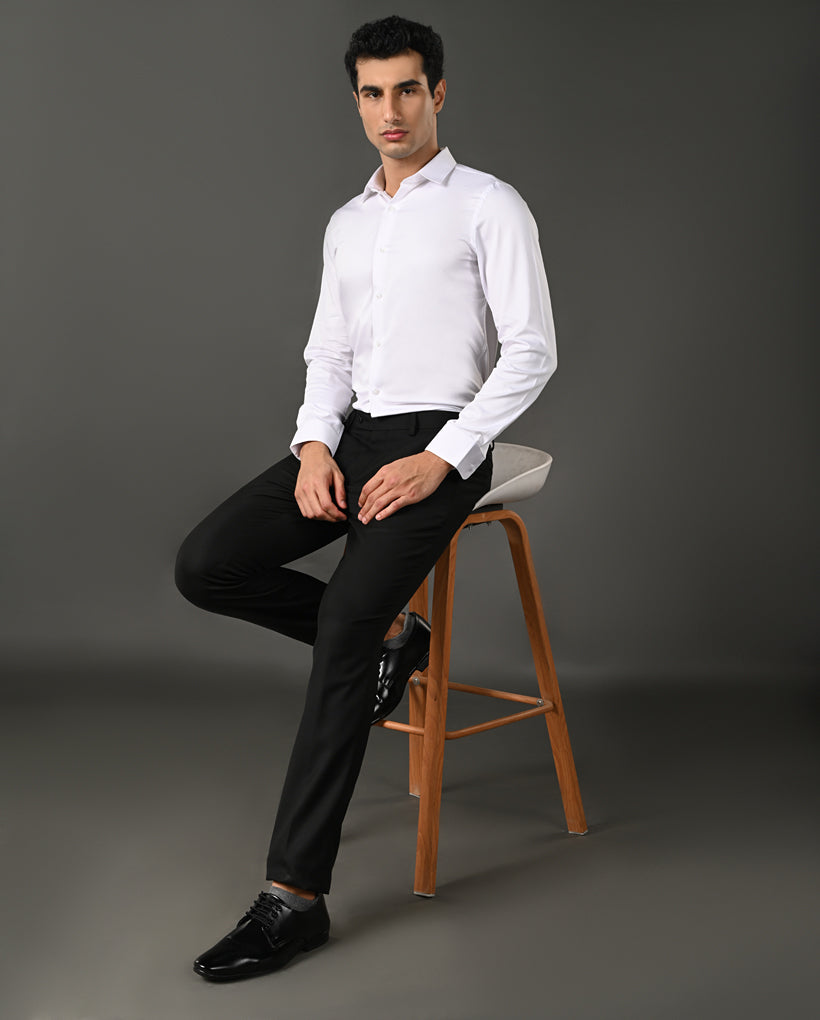 Close-up of a white dress shirt with collar and buttons on a gray background