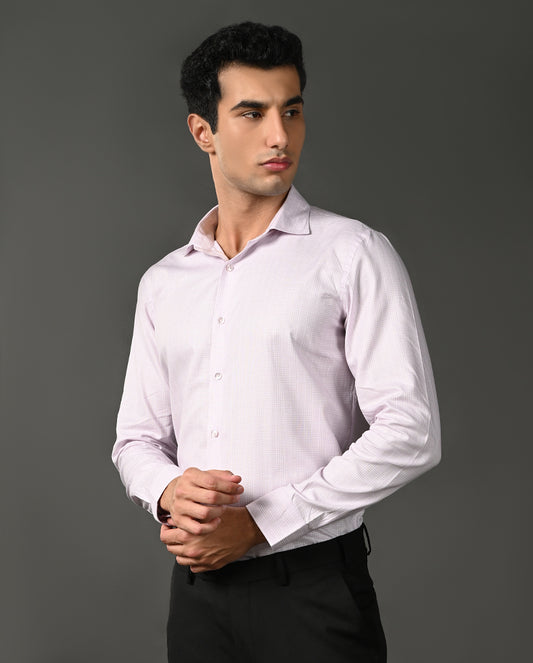Man wearing a light purple dress shirt against a gray background