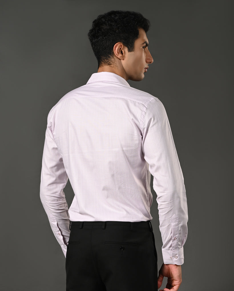 Man wearing a white dress shirt and black pants against a gray background