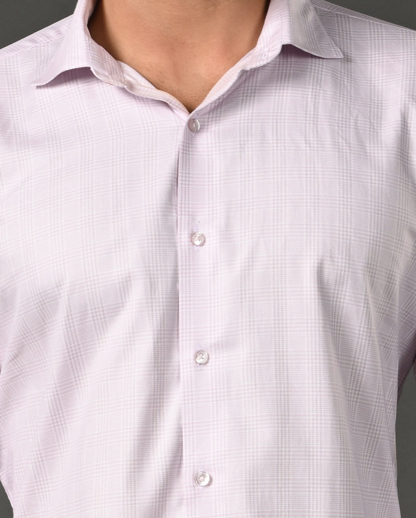 Close-up of a person wearing a light purple checkered shirt with a gray background