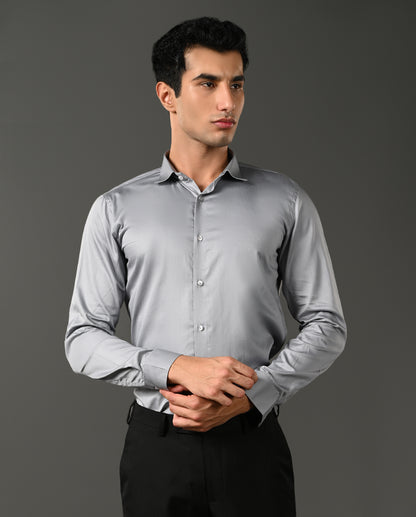 Man wearing a light gray dress shirt against a dark background- formal shirt for men