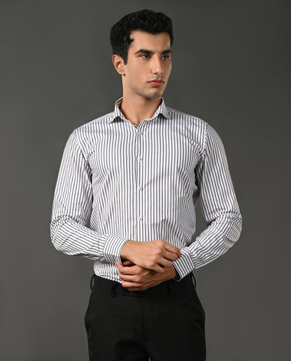Man wearing a striped shirt against a gray background