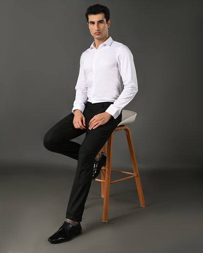 Close-up of a white dress shirt with collar and buttons on a gray background
