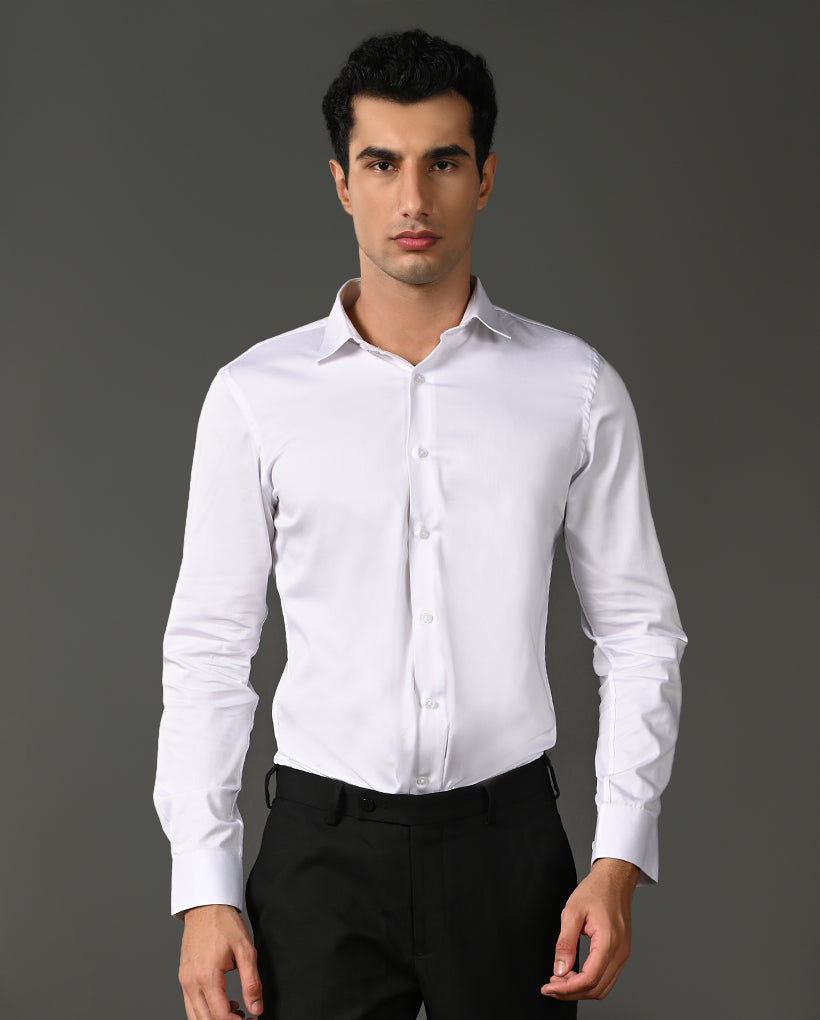Man wearing a white dress shirt and black pants against a gray background