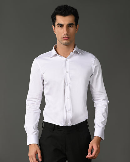Man wearing a white dress shirt and black pants against a gray background